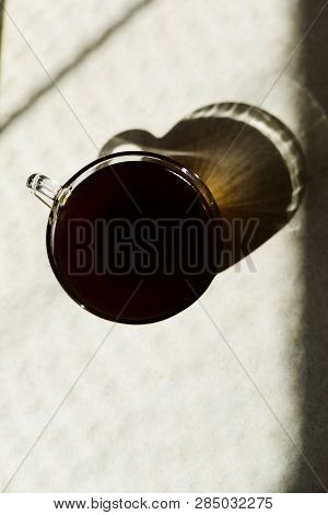 Black Coffee On The Breakfast In The Morning. Glass Cup And Sunny Weather.