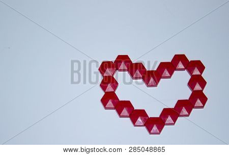 Red Heart Made Of Mosaic In The Center On A Blue Background