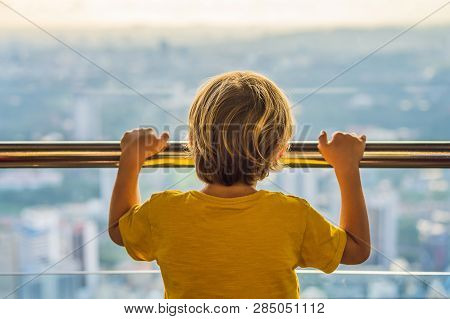 Little Boy Looks At Kuala Lumpur Cityscape. Panoramic View Of Kuala Lumpur City Skyline Evening At S