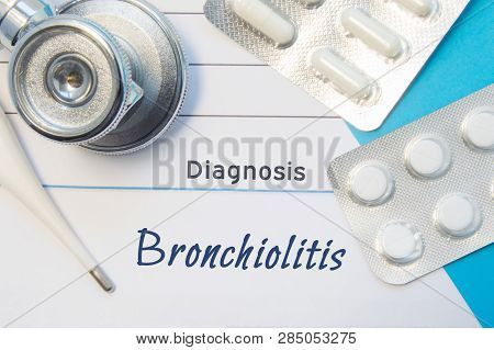 Diagnosis Bronchiolitis. Doctors Stethoscope, Electronic Thermometer And Two Blisters Of Pills Lying