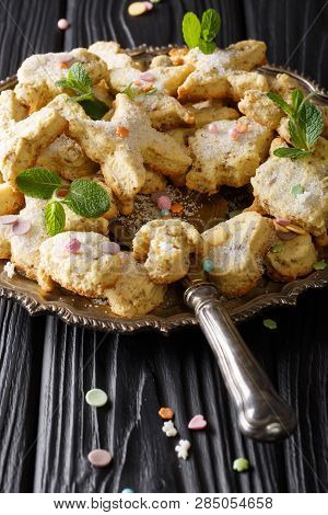 Mexican Christmas Hojarascas Cookies With Pecans Closeup On A Plate. Vertical