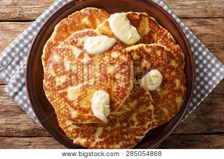 Delicious Sweet Griddle Cakes With Butter Close-up On A Plate. Horizontal Top View