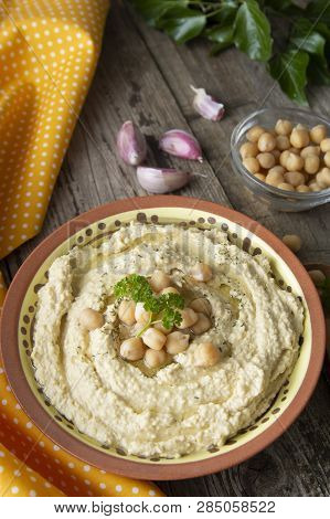 Delicious Homemade Hummus Pasta With Olive Oil And Cheakpeas. Wooden Table.