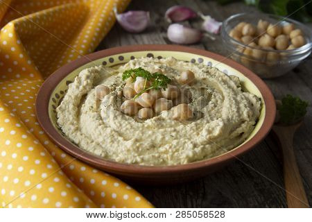 Delicious Homemade Hummus Pasta With Olive Oil And Cheakpeas. Wooden Table.
