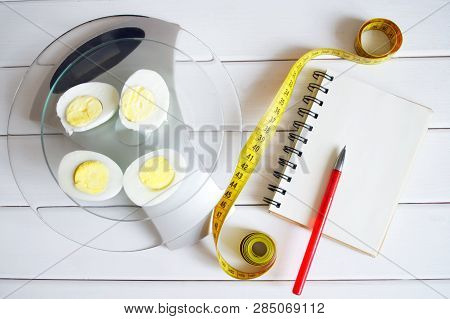 The Amount Of Protein, Calories, Carbohydrates And Fats In Food. Cut Egg On The Kitchen Scales. Slim