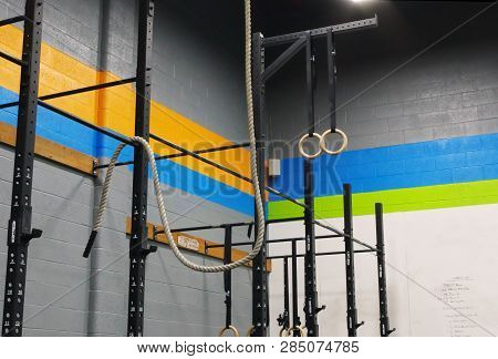 An Exercise Rope Is Attached To Bars In A Gym Near Handrings