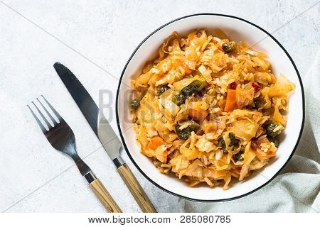 Cabbage Stew With Rice And Vegetables. Meatless Vegan Dish. Top View On Light Stone Table.