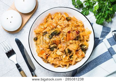 Cabbage Stew With Rice And Vegetables. Meatless Vegan Dish. Top View On Light Stone Table.