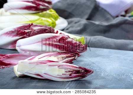 Group Of Fresh Green Belgian Endive Or Chicory And Red Radicchio Vegetables, Also Known As Witlof Sa