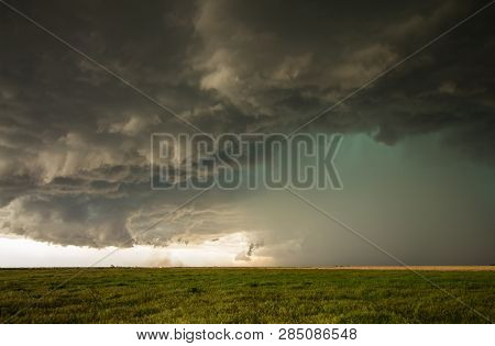 A Dangerous Supercell Storm Containing Torrential Rain And Hail Emits A Green Glow In The Sky.