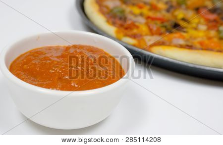 Pizza With Sauce, Bellpepper, Seasoning, Tomato In White Background