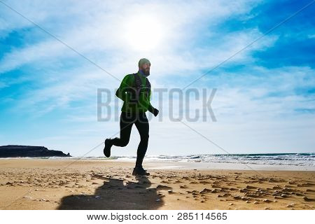 A Man Athlete Runs Along The Seashore On A Sunny Day. Trail Running. Mangystau Peninsula. Kazakhstan