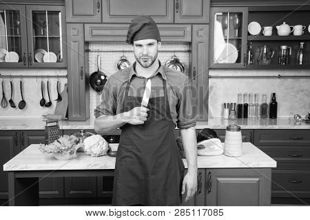 Man Chef Wear Apron Cooking In Kitchen. Man Use Sharp Ceramic Knife. Sharp Knife Professional Tool. 