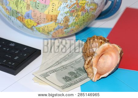Planning A Trip Around The World. On Holiday With The Whole Family. In The Photo: Plane, Money, Shel