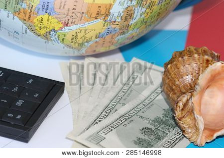 Planning A Trip Around The World. On Holiday With The Whole Family. In The Photo: Plane, Money, Shel
