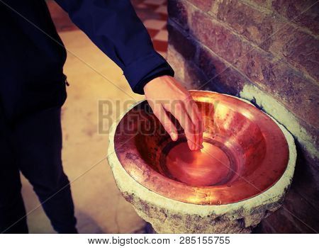 Hand Dip In The Blessed Stoup Water In Church And Vintage Toned