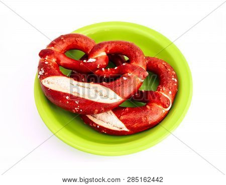 Two Traditional Bavarian Pastry Bretzes, Beer Snack On A Green Plate. German Salty Bakery Pretzel, I
