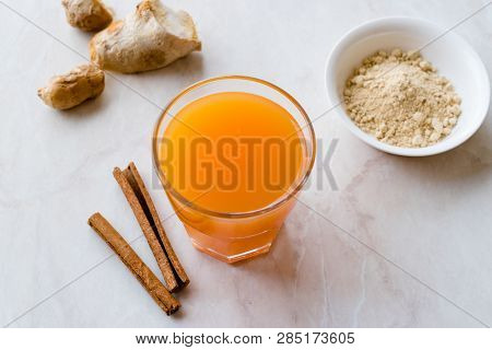 Jamu Healthy Asian Drink With Turmeric And Cinnamon Stick, Orange Juice