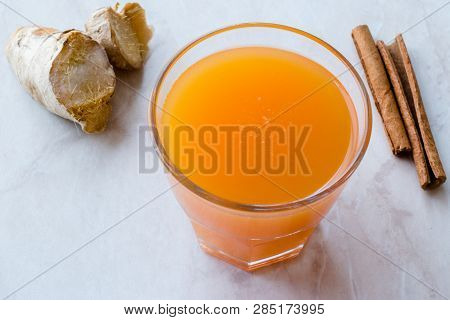 Jamu Healthy Asian Drink With Turmeric And Cinnamon Stick, Orange Juice