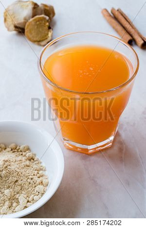 Jamu Healthy Asian Drink With Turmeric And Cinnamon Stick, Orange Juice