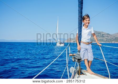 Little Boy On Board Of Sailing Yacht On Summer Cruise. Travel Adventure, Yachting With Child On Fami