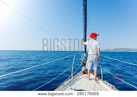Little Boy On Board Of Sailing Yacht On Summer Cruise. Travel Adventure, Yachting With Child On Fami