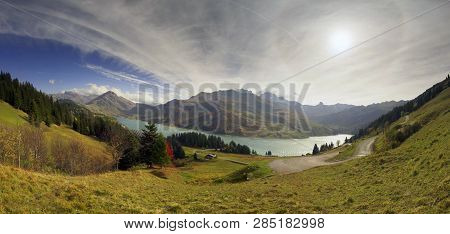 Mountains And Lake Roselend  With A Dike