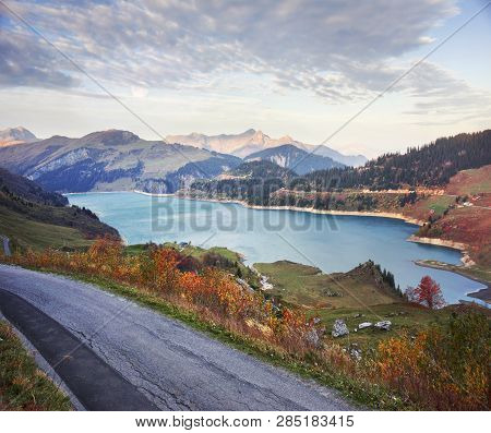 Mountains And Lake Roselend  With A Dike