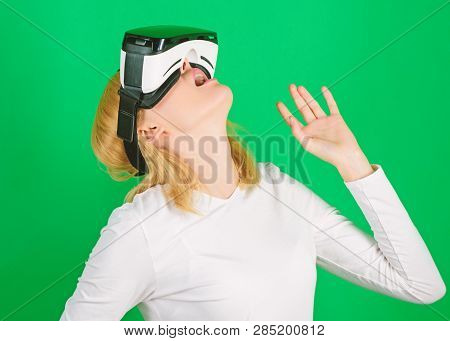 Person With Virtual Reality Helmet Isolated On Green Background. Woman With Virtual Reality Headset.