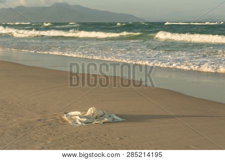Plastic Garbage On The Beach In The Sea, Plastic Bag Pollutes The Sea