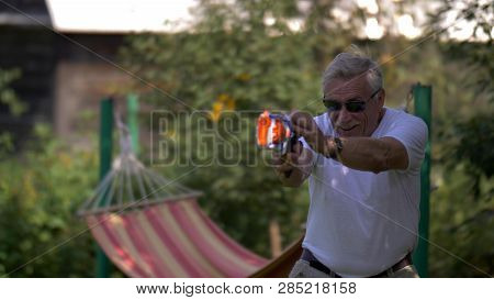 Senior Man With Toy Gun Fight On Nature