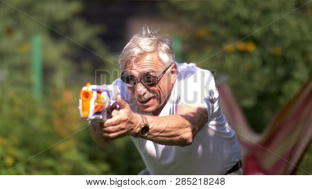 Senior Man With Toy Gun Fight On Nature