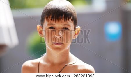 Portrait Wet Serious Boy After A Swimming Pool Looks At The Camera, Close-up