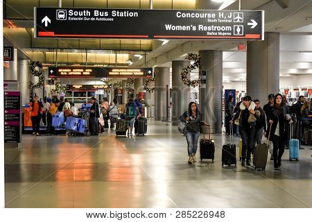 Miami, Florida. January 05, 2019. People Walking With Suitcases And South Bus Station Sign At Miami 