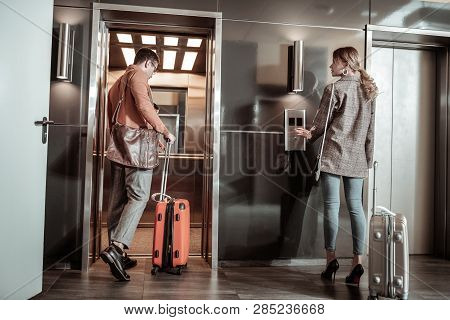 Dark-haired Husband Entering Elevator While Going To Airport
