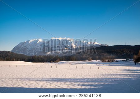 Snow Covered Mountain Range With Mountains Grimming, Schartenspitze And Steinfeldspitze On A Sunny W