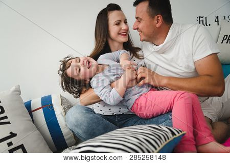 Smiling Happy Family And Young Funny Daughter. Family Concept.  On Background Bible Verses Philippia