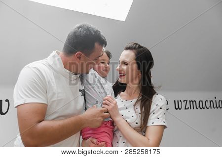 Smiling happy family and young funny daughter. Family concept.  On background Bible verses philippia