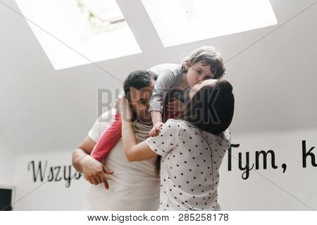 Smiling Happy Family And Young Funny Daughter. Family Concept.  On Background Bible Verses Philippia