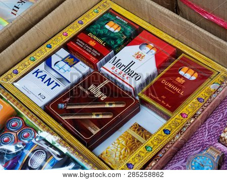 BANGKOK, THAILAND - JANUARY 23, 2019: Chinatown district. Fake cigarettes of famous international brands: accessories for funeral rituals.
