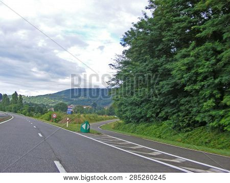 Fork Junction Sign With Crossroads Spliting In Two Way. Roads, View From Car