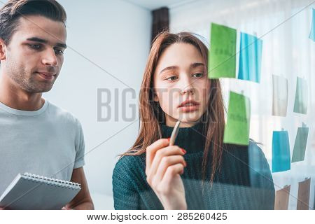 Portrait Of Coworker People Standing At Office Space Behind Glass Wall With Sticky Notes. Team Of Ma