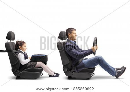 Full length profile shot of a young man in a car seat with a fastened seat belt holding a streering wheel and his daughter behind him isolated on white background