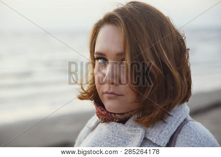 Serious Girl In Coat Looking To Camera Outdoors. Look With Reproach