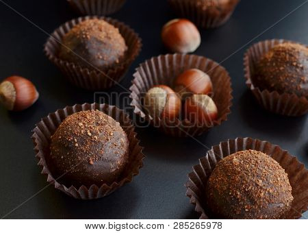 Chocolate Petit Fours With Hazelnut Over Black Background