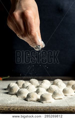 Uzbek National Food Chuchvara, Like Dumplings, Lie In The Shape Of A Heart, On A Wooden Board, Hands