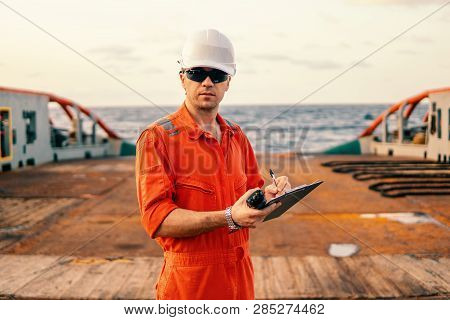 Chief Officer On Deck Of Ship Or Vessel With Checklist