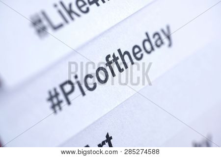 Popular Hashtag 'picoftheday' Printed On White Paper. Close Up.