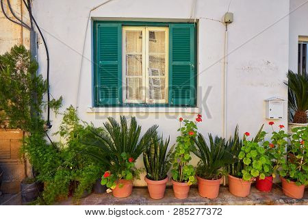 Typical Exterior Of Greek Traditional Town Street With Colorful Buildings And Marine Blue Door On Ka