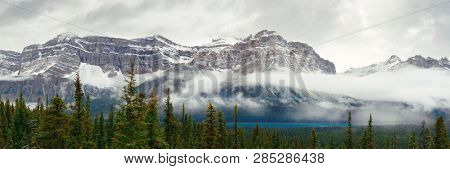 Bow Lake panorama with snow capped mountain and forest in Banff National Park